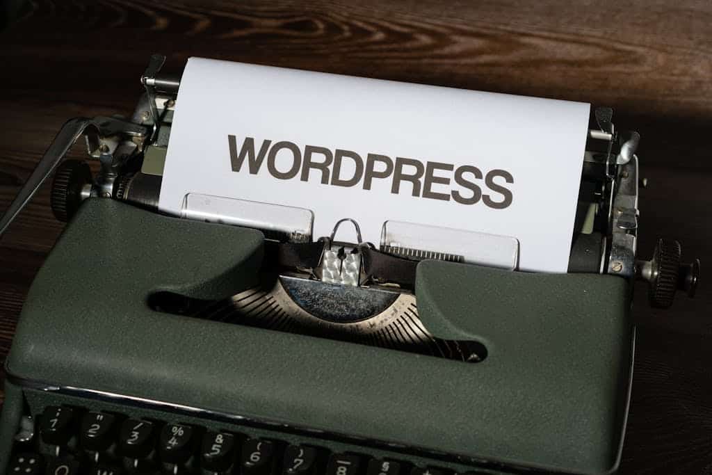 Close-up of a vintage typewriter with 'WordPress' typed on white paper.