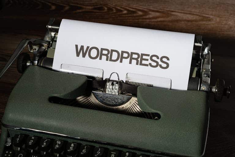 Close-up of a vintage typewriter with 'WordPress' typed on white paper.